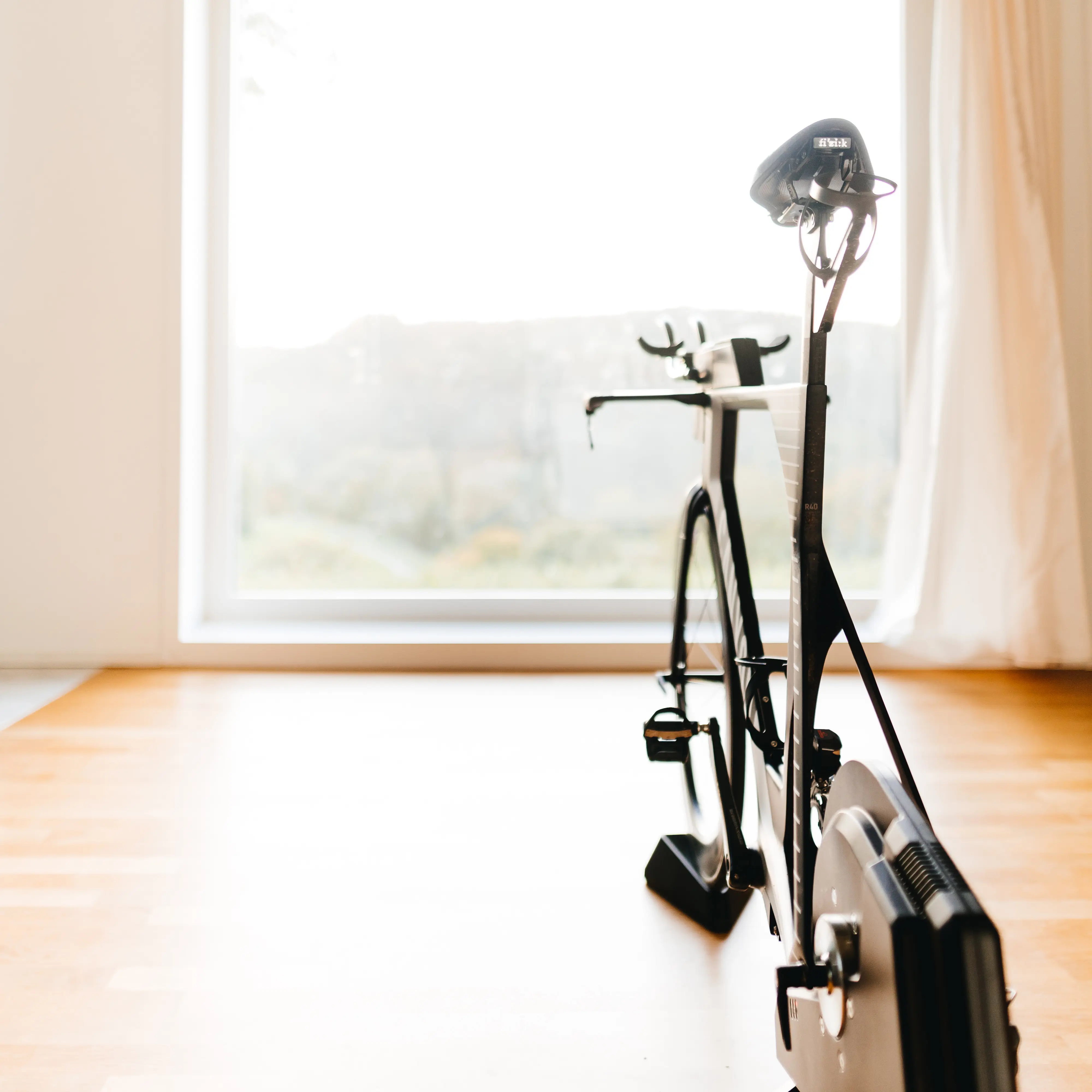 Indoor cycling bike beside a large window